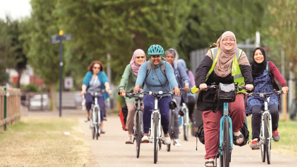 JoyRiders woman (Mariam) cycling and leading ride
