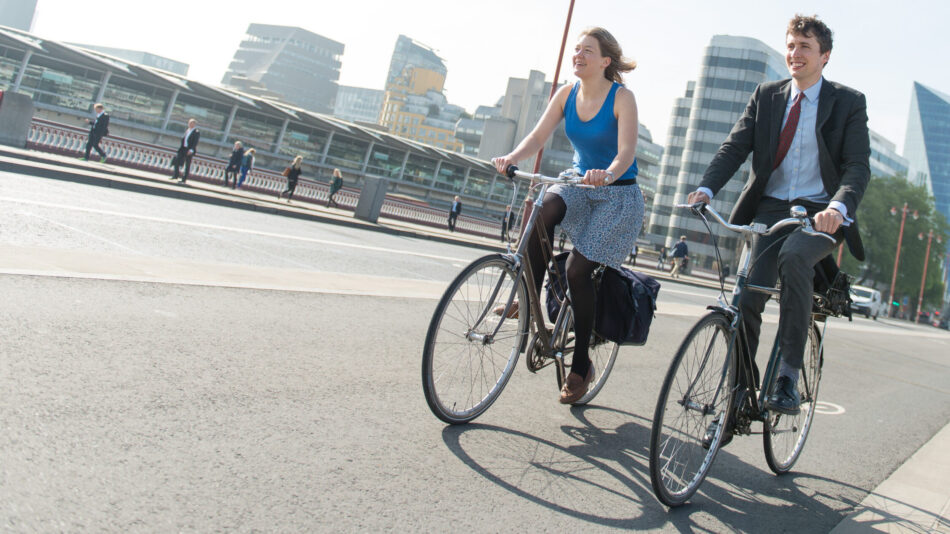 Man and woman cycling on cycle lane (cycle superhighway)