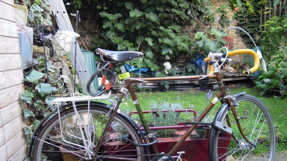 Bike parked and locked to planter in garden