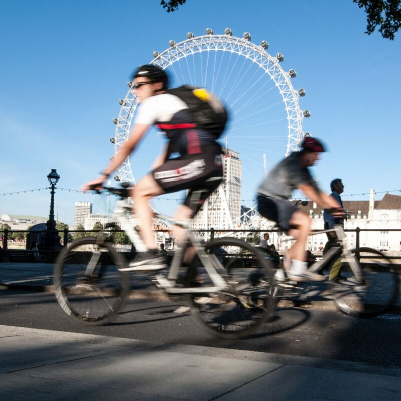 People cycling in motion on cycle lane (cycle superhighway)