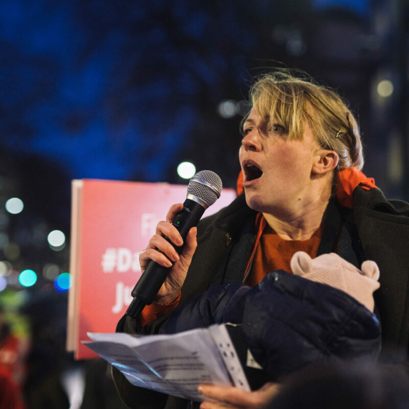 Woman with baby speaking at dangerous junction protest