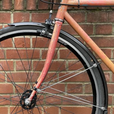 Close up shot of traditional fixed full length front mudguard fitted to a bike