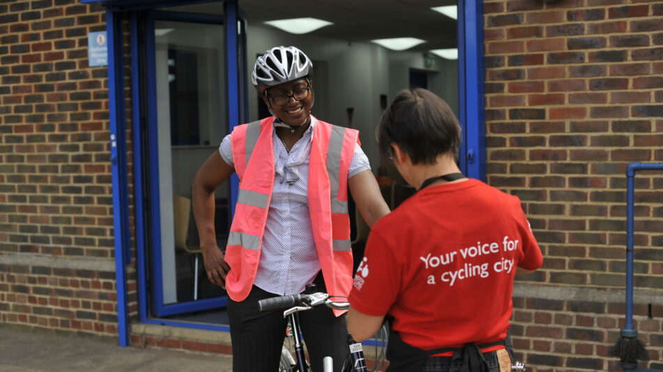 Instructor on bike and person in LCC t-shirt