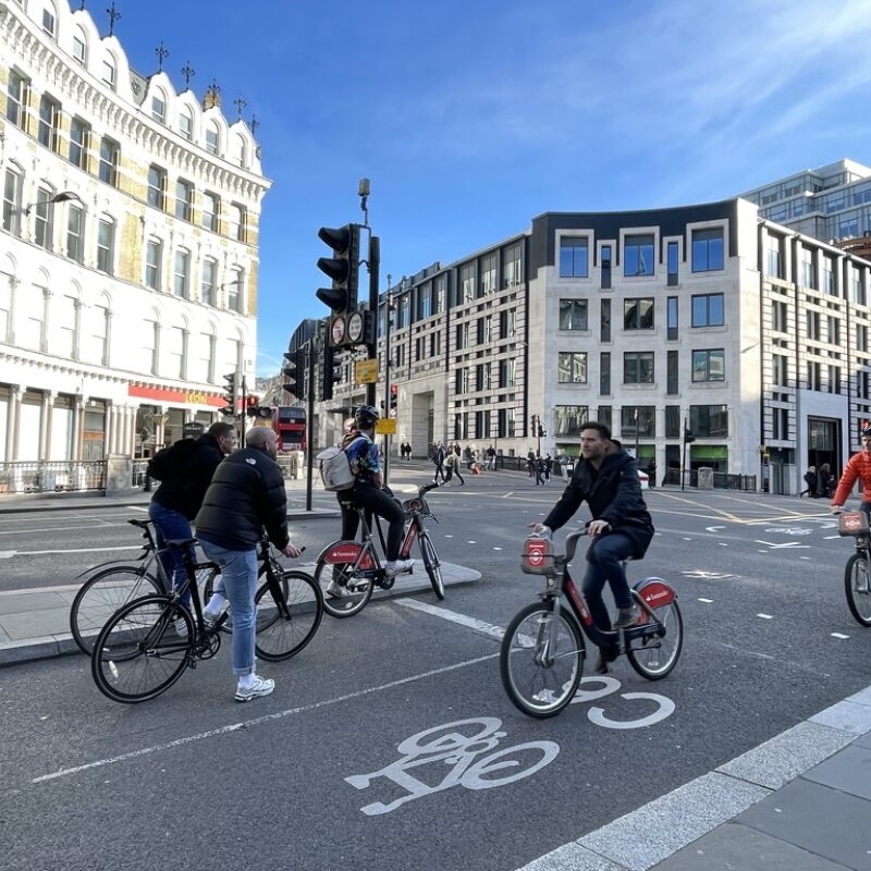 People cycling on cycle lane (cycle superhighway) at junction