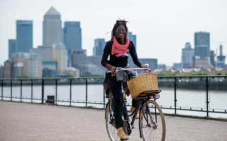 Woman with Dutch bike and basket by river