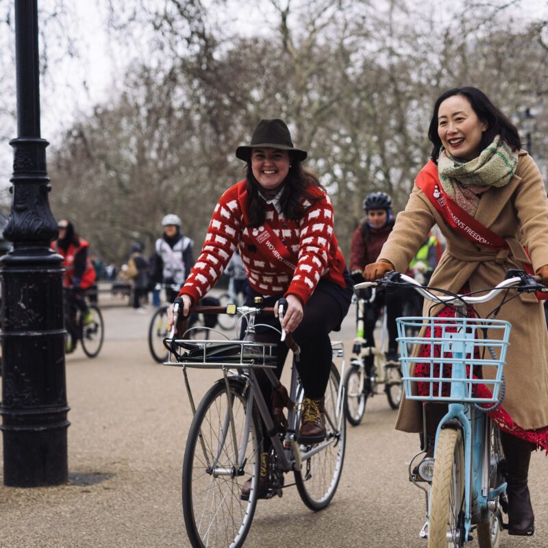 Woman with bike next to friend at protest