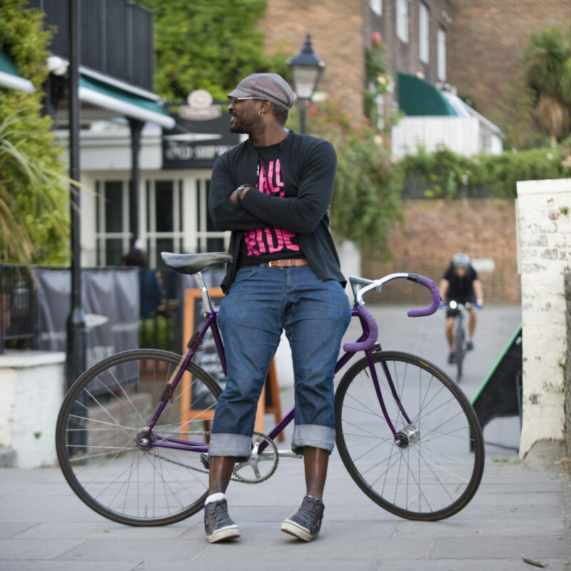 Man standing leaning on fixie bike