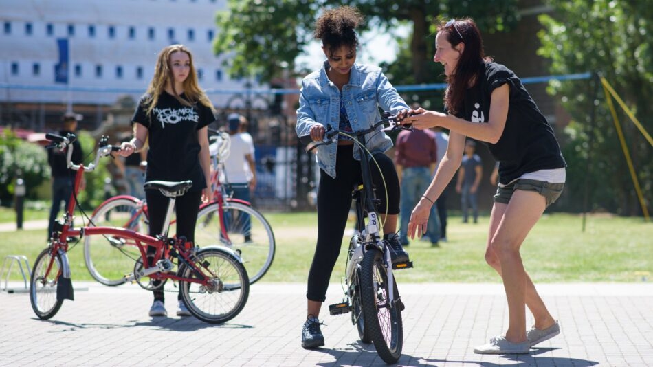 Cycle instructor with woman on bike