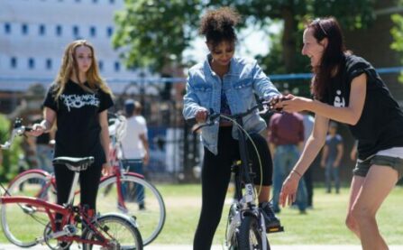 Cycle instructor with woman on bike