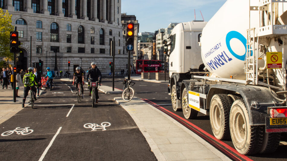 Cycle lane (cycle superhighway) with people cycling and lorry