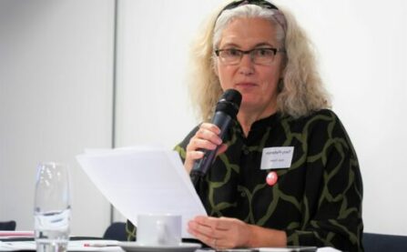 Woman with microphone at LCC AGM event