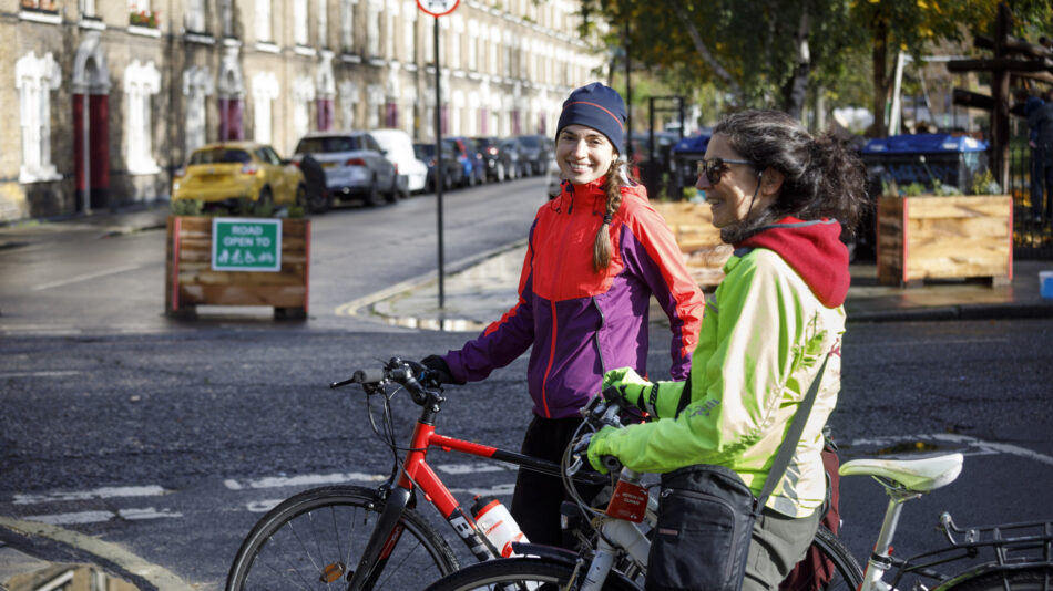 Woman in hi-vis on bike in Low Traffic Neighbourhood (LTN)